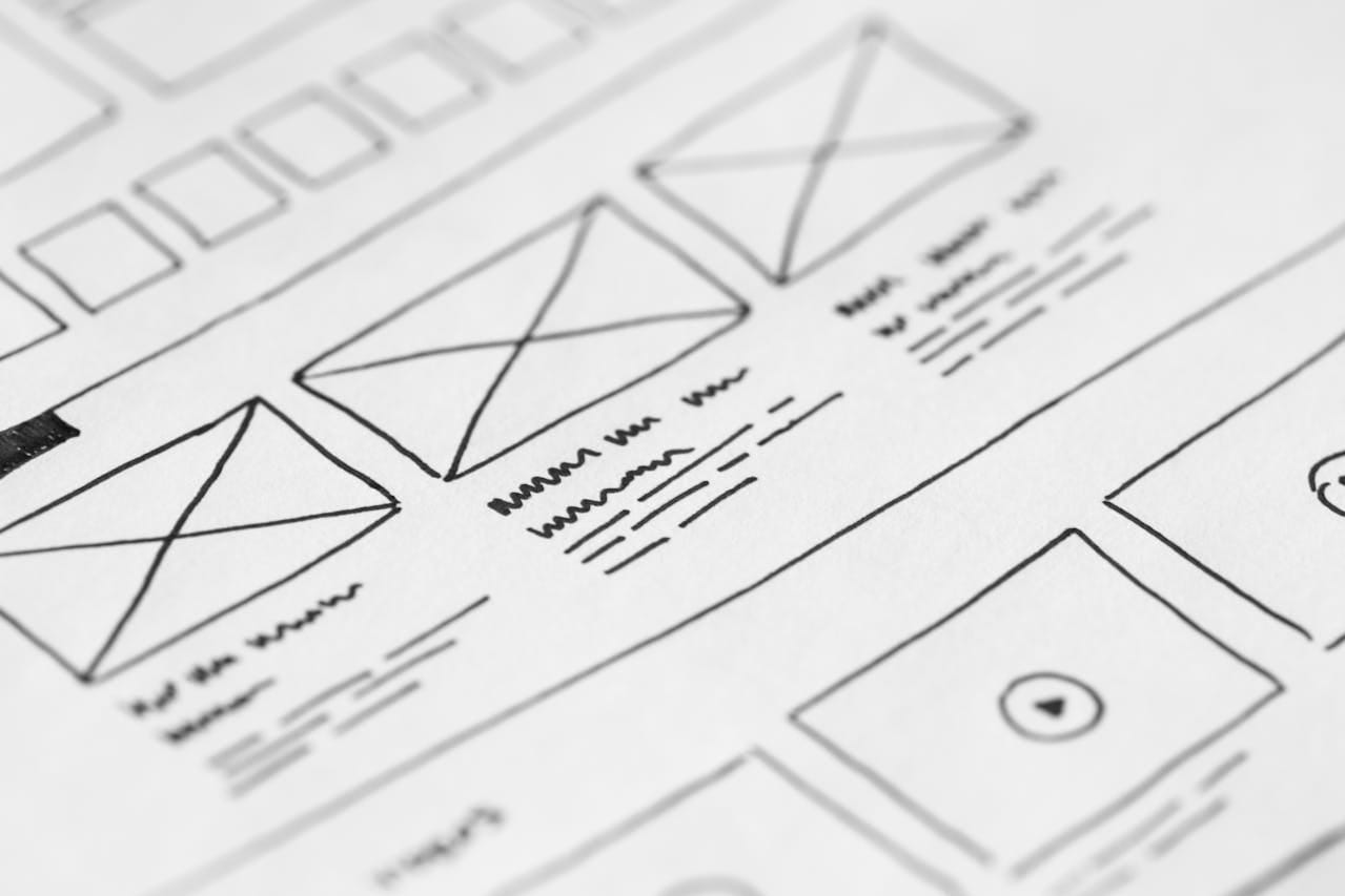 Wireframing and prototyping phase in UI/UX design, outlining user journey and interface structure.